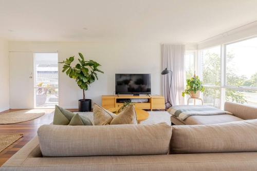a living room with a couch and a tv at Welcome to Casa Clifton! in Clifton Springs