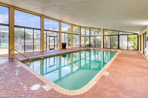 an indoor swimming pool in a building with windows at Seaside Beach & Racquet Club #4611 in Orange Beach