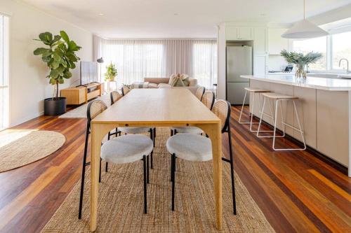 a kitchen and living room with a wooden table and chairs at Welcome to Casa Clifton! in Clifton Springs