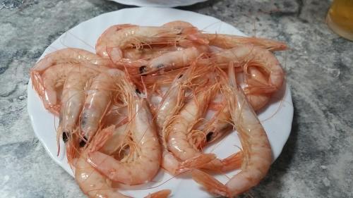 a pile of shrimp on a plate on a table at Apartamento Cortelazor in Huelva
