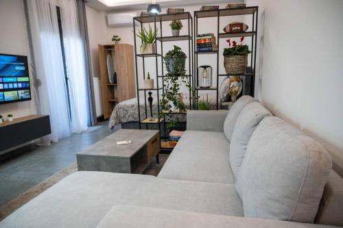 a living room with a couch and a table at Nick's Crib in Síndos