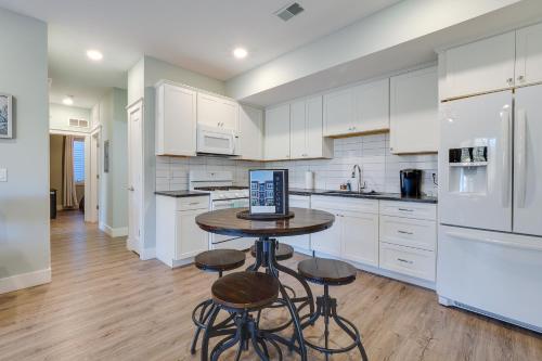 a kitchen with a table with a laptop on it at Walk to Front St! Traverse City Condo Near Skiing in Traverse City