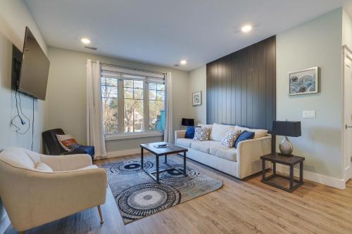 a living room with a couch and a tv at Walk to Front St! Traverse City Condo Near Skiing in Traverse City