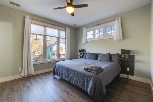 a bedroom with a bed and a ceiling fan at Walk to Shops on Front Street Traverse City Condo in Traverse City