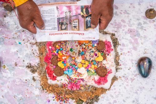 a person is holding a cake with sprinkles on it at Stardome Spiritual Experience in Ollantaytambo