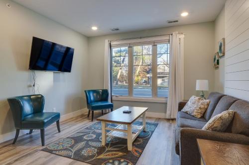 a living room with a couch and chairs and a tv at Front Street Retreat! Cozy Traverse City Condo in Traverse City