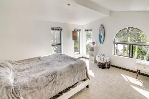 a white bedroom with a large bed and windows at Pool, Spa and Ocean Views - Modern Home in Malibu! in Malibu