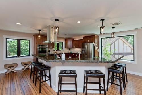 a kitchen with a island with bar stools at The Beatrice Estate estate in Grand Junction
