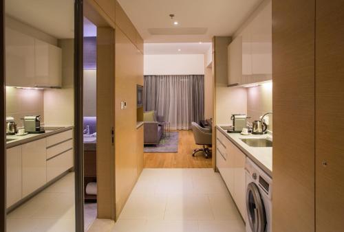 a kitchen with a washer and dryer at CM Service Apartment Tianjin in Tianjin