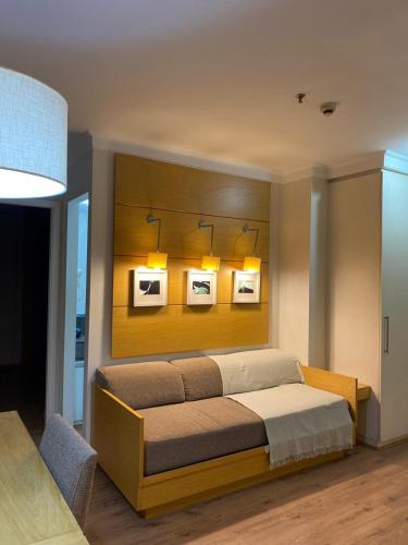 a bedroom with a bed with three pictures on the wall at Suitel Espetacular aeroporto Congonhas in Sao Paulo