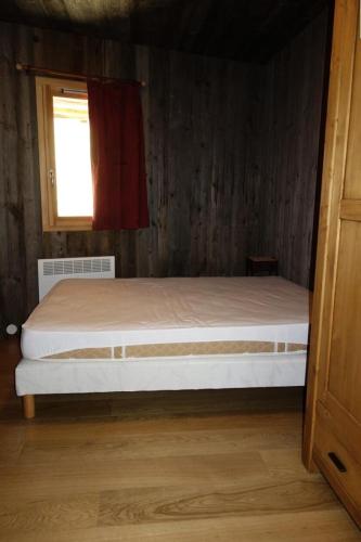 un lit dans une chambre avec une fenêtre dans l'établissement Résidence Taburle - APPARTEMENT ALPE D'HUEZ HAUT DE STATION MAE-2421, à Huez
