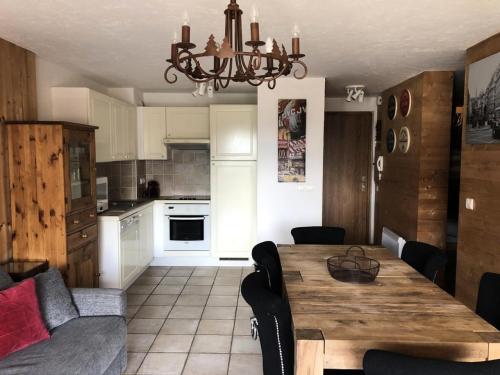 Il comprend une cuisine et une salle à manger avec une table en bois. dans l'établissement Chalet Alpina - APPARTEMENT ALPE D'HUEZ HAUT DE STATION MAE-2661, à Huez