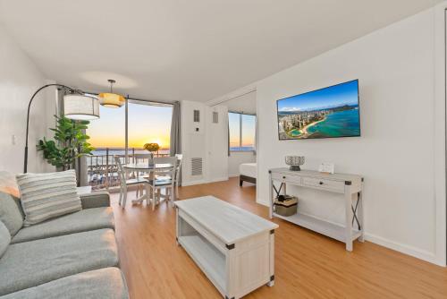 a living room with a couch and a table at Newly Renovated Oceanfront Waikiki- Ilikai Marina in Honolulu