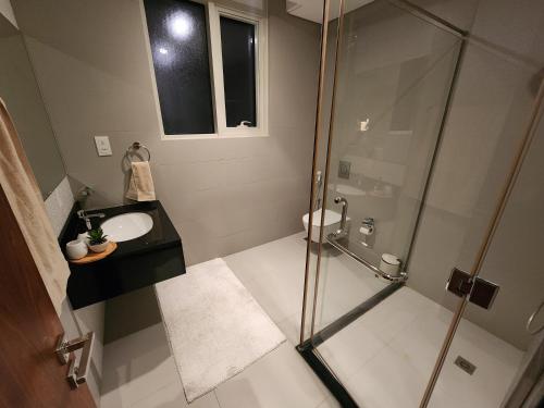 a bathroom with a shower and a sink at 3-BR Sea View Duplex on Island in Sanābis