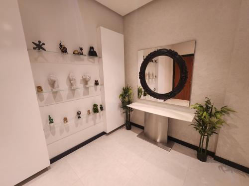 a bathroom with a mirror and a sink with plants at 3-BR Sea View Duplex on Island in Sanābis