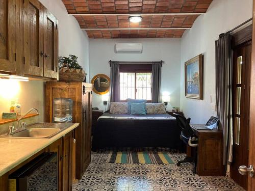 a kitchen with a bed in the middle of a room at PRIVATE OASIS! New Casita with Parking, Garden and Outdoor Kitchen! in Lo de Marcos