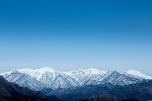 a view of a snow covered mountain range at Hotel Familio Minakami in Minakami