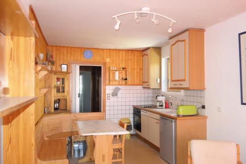 une cuisine avec des armoires en bois et un comptoir dans l'établissement Résidence 2 Anges A - APPARTEMENT ALPE D'HUEZ CENTRE DE STATION MAE-3171, à Huez
