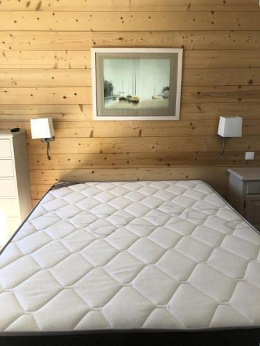 - une chambre avec un lit blanc dans un mur en bois dans l'établissement Résidence Horizon - Appartement 3 Pièces QUARTIER BERGERS-PIEDS DES PISTES-DEPART ESF MAE-3231, à Huez
