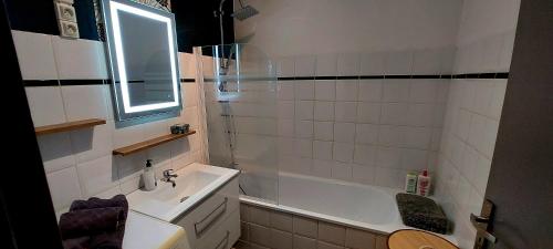 a bathroom with a sink and a tub and a toilet at Horizon Bleu in Bouzigues