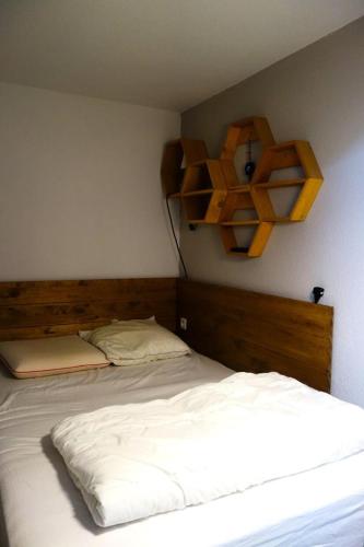 - une chambre avec un lit et des étagères sur le mur dans l'établissement Résidence Ecrin D 'huez - APPARTEMENT ALPE D'HUEZ DANS QUARTIER BERGERS MAE-3431, à Huez