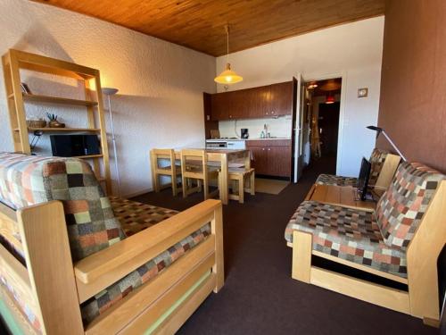 une chambre avec deux lits, une table et une cuisine dans l'établissement Résidence Milady - STUDIO + HALL HABITABLE ALPE D'HUEZ CENTRE STATION MAE-3451, à Huez