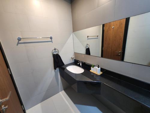 a bathroom with a sink and a mirror at 3-BR Sea View Duplex on Island in Sanābis