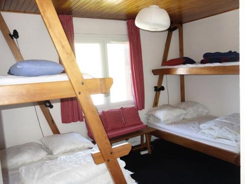 une chambre avec trois lits superposés et une fenêtre dans l'établissement Résidence Choucas - APPARTEMENT ALPE D'HUEZ AVENUE DU RIFNEL MAE-3691, à Huez