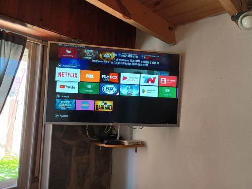 a flat screen tv hanging on a wall at Casita del Centro in San Clemente del Tuyú