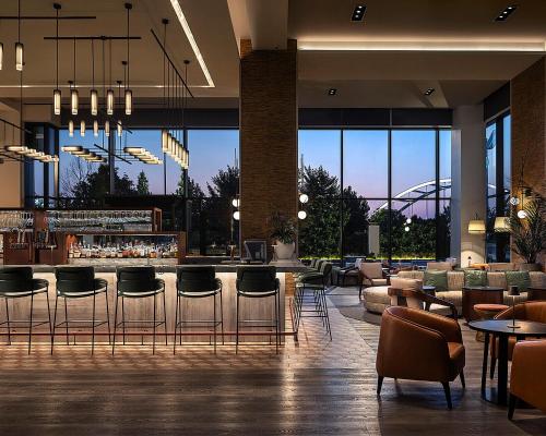 a lobby with a bar with chairs and tables at Four Seasons Hotel Nashville in Nashville