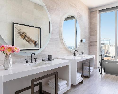 a bathroom with two sinks and a large mirror at Four Seasons Hotel Nashville in Nashville