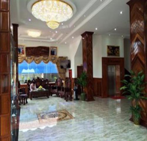 a lobby with a living room and a dining room at Emerald BB Battambang Hotel in Battambang
