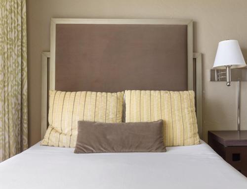 a bedroom with a large bed with a large headboard at Plantation Hale Suites in Kapaa