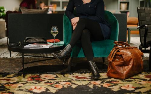 a woman sitting in a chair with a glass of wine at Best Western and hotel in Stockholm
