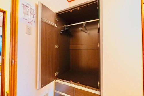 a closet with a glass door in a room at Mont Hotel Higashi mikuni in Osaka