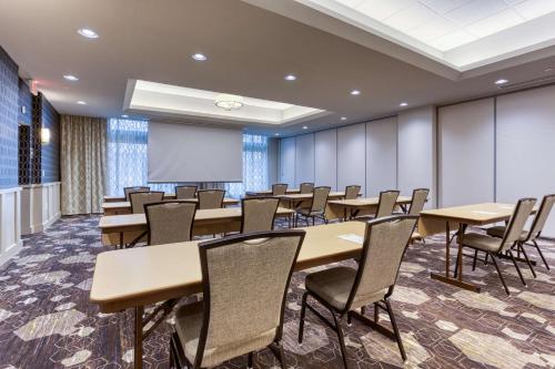 a conference room with tables and chairs and a projection screen at Drury Inn & Suites Cleveland Beachwood in Beachwood