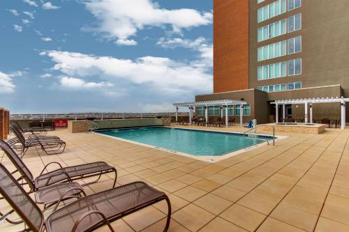 a swimming pool on the roof of a hotel at Drury Plaza Hotel Dallas Richardson in Richardson
