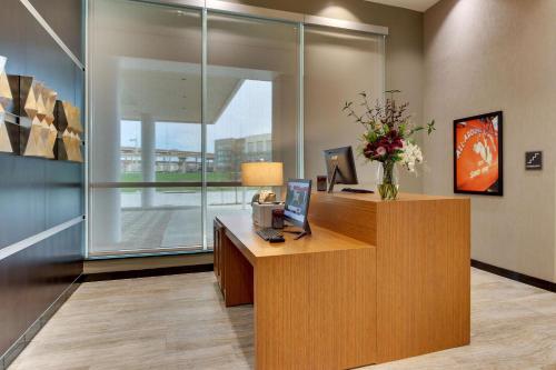 a office with a desk with a laptop on it at Drury Plaza Hotel Dallas Richardson in Richardson