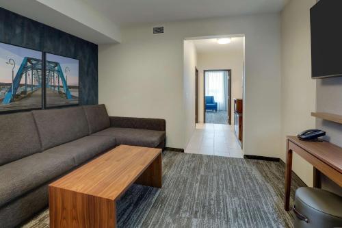 a living room with a couch and a table at Drury Plaza Hotel Chattanooga Hamilton Place in Chattanooga