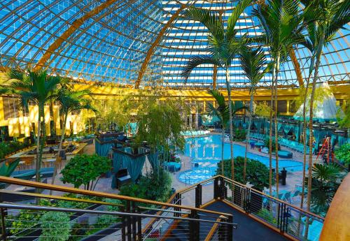 an indoor mall with a pool and a glass ceiling at Harrah's Resort Atlantic City, A Caesars Destination in Atlantic City