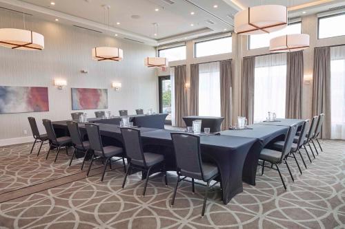 a large conference room with a long table and chairs at Sandman Signature Plano-Frisco Hotel in Plano