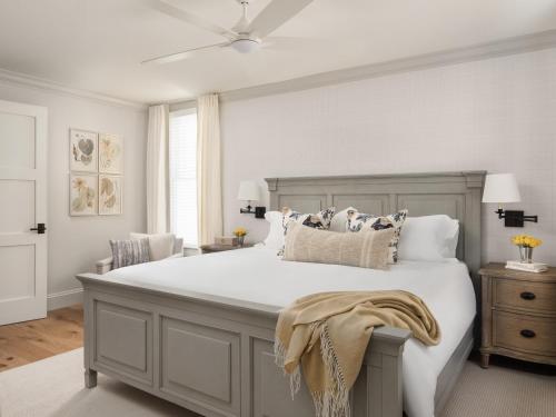 a bedroom with a large white bed with pillows at 1313 West Luxury Boutique Hotel in Annapolis