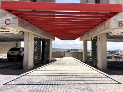 a red roof over a building with a parking lot at Elegante depa cerca de los arcos con amenidades in Hércules