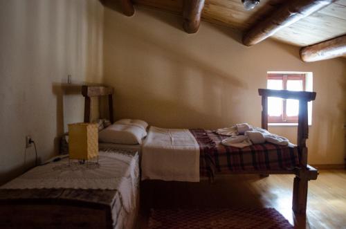 a bedroom with two beds in a room with a window at Sarris House in Xirokámbion