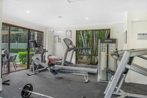 a gym with two treadmills and two tread machines at Elvis - The Great Seaside Escape - Luxury Stay in Coffs Harbour