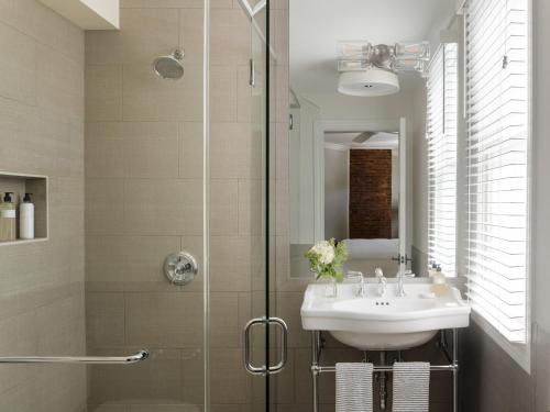 a bathroom with a sink and a shower at 1313 West Luxury Boutique Hotel in Annapolis
