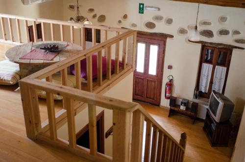 a room with a wooden staircase and a living room at Sarris House in Xirokámbion