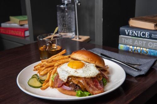 a plate of food with an egg sandwich and french fries at InterContinental Minneapolis - St. Paul Airport by IHG in Minneapolis