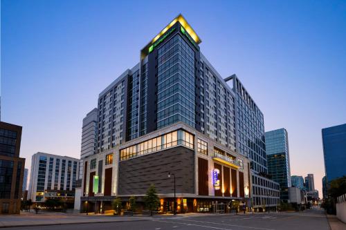a large building in the middle of a city at Holiday Inn & Suites Nashville Downtown - Broadway by IHG in Nashville