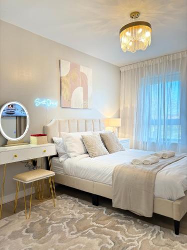 a bedroom with a bed and a desk and a mirror at Lux Stays - Luxury Leeds City Apartment with Jacuzzi & Free Parking in Leeds